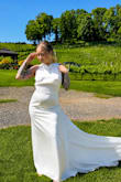 I got this dress for my micro wedding in Linville Falls, and it was PERFECT. I did have to get it taken in a little around the chest because I'm 3 inches tall and it's long, so I'm not taking any points for it.
This dress was comfortable and looked so good on. The material is strong but sits delicately like you'd want in a wedding dress. I wore it hiking, and it still stayed looking beautiful. - Bailey G.