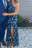 I recently wore this to a wedding and got a lot of compliments. There is a subtle shimmer to the material. It was a bit tight around the midsection but I think the next size up would've been too big. - Robyn L.