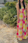 This is the cutest little day dress! The material is a nice thick linen-type, and it feels of good quality. The fabric feels substantial but not heavy or uncomfortable. The colors are beautiful and vibrant, much like what you see in the picture. The front is definitely plunging, so I would not say modest (particularly if you're bigger-chested). I purchased an XS, and it fit perfectly/comfortably; however, there isn't stretch to the fabric, so keep that in mind. I am 5'4, and it was def more maxi than midi length on me. As other reviews have mentioned, the beading on the belt is a pretty touch. It was the perfect dress for wine tasting. If you're considering it and it's in stock, get it! - Jay J.