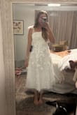 I love this dress and the three-day floral details. I was between sizes and fit into both a small and a medium, but the medium fit without any trouble. - Averey B.