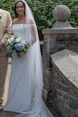 I absolutely loved my wedding dress and would highly recommend it! Overall, it was so nice, fits well, and I received so many compliments throughout the entire day. It has a beautiful little trail that looks gorgeous in photos, but the best part was that it was incredibly easy to walk in without any problems at all. There were just two minor things to note: The dress is a bit heavy, so I did find myself having to pull it up a few times, but it was nothing crazy or unmanageable. The material on the bust is sheer and delicate, sort of like wedding veil material. It was designed to sit lower and cover the bust area, but it kept riding up higher toward my collarbone/chest area. Eventually, I just let it do its thing and didn't worry about it. Even with those small adjustments, the dress was absolutely perfect for my special day, and the endless compliments made it so worth it. - Isla N.