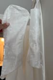 I bought this dress to wear to my bridal shower. I tried it on right when it arrived and it fit great and I was so excited to wear it when the shower came around. It sat in my closet until the event, I did not put it on after the initial try on. The morning of my shower, the zipper to the dress was extremely difficult to zip and when I finally got it zipped, the entire zipper busted and there was no fixing it. Obviously I freaked out and luckily had a friend who's wedding was this year and had an extra white dress. Needless to say, this material is extremely cheap and I would not recommend purchasing this dress if you want it to hold up for an important event! Will not be doing my dress shopping at lulus after this incident. - Cecilia V.