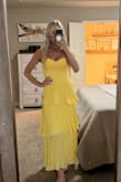 I am shocked a dress made like this worked for my chest! I'm petite (size 0/25) with implants (size 32DDD) and it fit perfectly. Bought this for my stepdaughter's bridal shower, which is "fairytale" themed. The yellow is brighter than shown on the model. I wish it were more buttery yellow as shown. I can't decide if I'm going to exchange it for a softer color or not. My stepdaughter loves this one, so I'll probably keep it even though it's not exactly what I was hoping for. - Michele L.