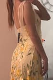 Loveeeee this dress! The flowers have kind of an ombre effect, as they're more dense towards the bottom of the dress than at the top. The dark yellow flowers pair beautifully with the light yellow dress, the colors are exactly as described. The material is stretchy, and has lots of give. Overall, very beautiful and comfortable! - Emma B.