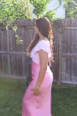 This dress was beautiful. I was a bit worried about the fit, but it was so comfy. The back of the top is adjustable, which is so helpful since everyone's body is different. The back is open but not too revealing or uncomfy, the length is so cute and makes it a little flowy. The colors are also so so flattering. - Scarlet A.
