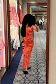 A vibrant orange and very comfortable fabric. Wore it on a cruise to dinner and felt like I fit the occasion perfectly. I am very short and it hit just above my ankles. I don't typically write reviews but the price and dress is great. Love it! Thank you Lulus - Anna L.