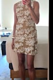 This dress fits true to size, is not too short, has stretch and is flattering to the figure. It also allows you to wear a regular bra, if desired. Very pleased with my purchase. - Lisa S.