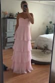 Love the dress. The colour is the perfect pastel pink. The ruffles are adorable. However, the clasp on the back of the dress came broken (missing the hook part). Unfortunately, it cost too much to exchange it, so I will just find a seamstress here to sew one on. Disappointing that it came broken and with some loose strings for the price I paid. But besides that, it's a flattering dress. - Kyleigh K.