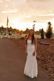 This dress was beautiful. I loved the lace and how simple it was. The train was the perfect length and it was perfect for our more casual wedding. I got a size small ( I am 5 ft 7 137lb), and I probably could have gotten a medium, however, the fabric is stretchy, and I wanted it tighter. I had to get the straps shortened, and we ended up adding a sparkle belt just for fun, but other than that it was perfect for the big day! The lace detailing was so beautiful. Couldn't recommend enough! - Kylie Z.