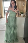 I bought this dress to wear as a bridesmaid, and I'm so happy with it! The material feels high quality, and the sage green color is even more beautiful in person. The subtle sparkle woven into the fabric adds just the right amount of detail without being over the top - very elegant.
The fit is true to size, though it does run a little long, so I'll need to hem it slightly. I love that the off-the-shoulder straps are versatile - you can wear them loose and draped like in the photo, or pull them up as actual straps for a more secure fit, which will be great for dancing and moving comfortably.
Shipping was super fast, and overall I'm extremely satisfied with this purchase. Highly recommend! - Galit B.