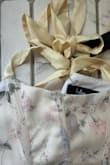 This top is soo cute but the pics are so off. I know the title says cream but even the reviewer pics look whiter than the item I received. It's straight up yellowy tan. Look at pics attached compared to the item pictures, so far off. I may keep it just bc it fits and is cute, but I need to find something exactly like the item pics, white with pink florals to go with my bday dress. Lulus can you lmk if this just happens to be darker than usual and I could return for a replacement? - Emily T.