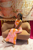 I received so many compliments on this dress. The theme was orange and pink and this dress matched the theme of the tea party with my sisters in Christ. The material is not stretchy, but I wanted a fitted look so a small fit me perfectly. I did wish the split was a little lower below the knee, it was slightly above the knee but I made it work. If you're 5'5 or under, it will be long, I wore heels to balance it out. Overall, I love this dress and would definitely wear it again - Ka'Liyah A.
