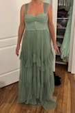 I liked the dress, but it looked darker than in the photos on the website. It was pretty long, would have had to hem it even with heels. I ended up returning it. It's very shimmery, mermaid vibes for sure. Also there was a small snag on the outer layer. - Melanie C.