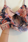 I love the fit both the top and skirt have extra stretch in the back which guarantees a perfect fit! The top does not have a zipper but so the stretch helps it get on and off. The problem was with the stitching on the top. There is a little keyhole in the center of the top but it is much larger than pictured. The top wraps like a Bando bra, but the fabric is so thin the bottom needs to be stitched down to the bottom panel or some serious under boob happens. It is only held down with one tiny thread and when I opened the package it was already ripped on one side. The pictures help show how dependent the entire top is on the top small stitch; the entire top needed attached to the bottom panel. The skirt is amazing with a stretch on the waist and a zipper on the side. It had a nice double lining so no worries about it being too thin unlike the top.  Still love the fit, just disappointed in the tops quality and how it was already broken& - Kali A.