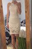 The fit is great it's true to size. Being taller I do wish the slip part was longer. The material is kinda cheap which was disappointing considering the price wasn't all that cheap. The dress is VERY thin. I was planning to wear this for graduation but will definitely need some spanx or something under it. You can like see a little too much from the back! Over pretty dress, just disappointed in the quality - Ashley R.