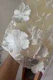 I like the dress and it's very fun, but it doesn't feel quite like the photos. It's definitely is more yellow than pictured. The waistband is really scratchy from the tulle, and the flowers aren't sewn on well (will have to fix this myself). I like it, and I'm keeping it for my wedding since I don't have time to find anything else, but I don't think it's worth the price considering the flaws and it's not shown very accurately. - Jordan M.