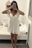 I absolutely love this dress! The white fabric feels incredibly high quality. It's thick enough to feel luxurious while still being comfortable to wear. It has such a soft, romantic look that makes it perfect for special occasions or a dreamy summer outfit. The only thing I'd mention is that it runs a little big in the bust, so if you're between sizes or have a smaller chest, you may want to size down. Other than that, the fit is beautiful, and the overall design is elegant and feminine. Definitely a dress that looks even prettier in person! - Lin K.