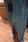 This dress is sewn incorrectly. The liner got partially sewn into the dress seam just above the slit and it bunches and will not lay normally. Looks terrible because of that. The color and fabric are otherwise beautiful and I'm sad I wasted my money on the dress and cannot wear it. - Abigail L.