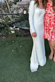 Where do I even start with this story? Long story short, the dress that someone offered to make me didn't turn out how I had hoped a few days before our wedding, and this dress became the hero of the story- I had it as an optional reception dress. I was so comfortable- no mobility issues and the dress wasn't falling off. I felt timeless. Since it was a last minute change, we didn't have time to take it to a seamstress so, my mom fixed the shoulders- originally with just safety pins and then she was able to sew it. We took the bustle from the other dress and made our own. I would recommend clothing tape for the front and back so that you're not self conscious. If you can put in a bustle, it would be a great idea since the train is beautiful and you'll want to dance in this guy. Material wasn't too heavy and I had the time of my life on the dance floor in this. Thank you so so much, Lulu's!! I am so grateful. I can't begin to express how much I appreciate this lifesaver dress. I only have photos of it bustled! - Lela K.