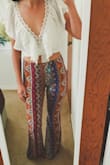 This shirt has perrrrfect for the boho look I was going for when I wear my high-waisted bell bottoms for my engagement photoshoot coming up! So comfy too and I love that I don't feel or look completely naked while wearing it like I do with most crop tops/bralettes. After reading the reviews, I decided to size down from my usual Small to XS & i'm really glad I did! It definitely runs a little bit large. However, my chest is pretty flat so I feel like I don't fill it in as much as it's made to be. So the straps somewhat are easy to fall down if I move around a bunch. But, with a little double-sided tape, it stays on pretty much perfectly. I imagine with a bigger bust tape might not be necessary and it would fit better. Also, the lace detail is SO pretty and all the fabric feels like such high quality!!! Stoked to own this shirt! - Brandi L.