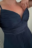 This dress is a simple, basic, classic dress for wedding guest attire. The fabric is see-through, feels cheap, and leaves this weird residue feeling on my hands after touching it. The bust is too large, I can fit three fingers between my breast and the dress. I'll have to use fabric tape or have it tailored. Don't really want to do either. So, it's more for someone top heavy. I'm pear-shaped. Not sure if I'll keep it. For reference, my measurements are 38" bust, 34" waist, 48" hips, and I ordered XL. - Natalie C.