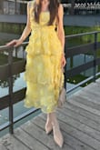 I had the straps shortened by a tailor because the dress sat too low on me, but a smaller size would have been too tight. After that, it fit absolutely perfectly. The yellow color and style are so beautiful, and I received so many compliments. - Anna R.