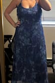 I purchased this in a size large originally. I was so surprised how loose it was. I didn't even have to undo the zipper. I just was able to just slip into the dress. I decided to give the dress another chance and ordered a medium. It is still loose. I am assuming it is supposed to be like this. It's very loose and flowy and does nothing for my figure. Unfortunately, I will be returning. - Alexa H.