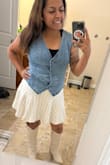This vest really makes the whole outfit! I absolutely love the denim look and how easy it is to style. Just keep in mind that it does run small. I originally ordered a medium but ended up exchanging it for a large, which fit much better. Definitely recommend sizing up! - Carol R.