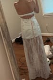 I wanted to love this dress so much, but it didn't meet my expectations. I am 5'6, 130-135lbs, I originally ordered the small and exchanged it for the extra small. The small dress fit, but the bust was very big. For someone who has 34D boobs, I was surprised by how much room I had between my chest and the fabric. The boning of the dress was a huge problem for me. The back was bulging out and made it look like there was a lot of extra room to fill. So I exchanged for the xsmall. The extra small fit but was a tad tight. The fabric was scrunching up, but it touched my bust area perfectly. The back was still bulging out, but now the strap that you rely on for support was extremely tight. I also noticed that my back was starting to get itchy and red. The strap has clasps like a bra and is not super supportive. I would have loved this if the strap was stretchy or a tie or if there was no boning, which ruined the dress for me. I found more of this styled dress elsewhere with no bulky boning. - Jamie R.