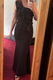 The quality of the material is excellent. Thick and stretchy. The one-shoulder ruffle detail adds a whimsical element to an otherwise plain black dress. The mermaid silhouette makes me feel sexy while looking classy. I'm very tall and the length was perfect for me! - Vanessa R.