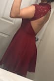 It's exactly as it is on the picture color and all, but I thought the dress itself would be of a lighter material But it's a pretty thick heavy material, the seam between the top part and the skirt bothers me for some reason and I have no idea why but it fits perfect on the neck and overall areas, the back part is amazing! But the color and material is the only thing that bugs me just a tad bit. Other than that, this is a beautiful dress if you like them a bit above knee length and flowy. - Joanna O.