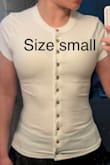 The shirt runs extremely small, especially compared to how it fits in the model photos. I order from Lulus all the time and I normally wear a size small, so that's what I ordered. You can see in the first photo that the shirt fits super skin tight, puckers all over, and highlights every bump and curve on my stomach. I wanted it to drape down in a slightly loose way like in the model photo, so I exchanged it for a size large hoping that would do the trick. As you can see in the second photo, the large is still very fitted and still doesn't drape at all like the model photo. It's really meant to be a tight shirt even if you go up two sizes. I'm going to keep the large because it's kind of cute when I wear it as an open jacket completely unbuttoned, but I'm really disappointed in the fit overall, and I don't think it fits as advertised. - Angelica S.