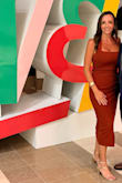 I absolutely love this dress! The fit is incredibly flattering, especially if you have an hourglass shape or a fuller bust. It defines the waist and skims the body without looking overly tight, and the midi length keeps it sophisticated. The neckline is also really flattering and gives just the right amount of openness without feeling too revealing. The rust/cinnamon color is even prettier in person and looks especially beautiful with a tan and gold accessories. I wore it to an evening awards dinner and felt polished, feminine, and comfortable all night. One of those dresses that looks simple on the hanger but is SO good once you put it on. Definitely a keeper! - Tana K.