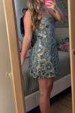 I bought this for my daughter to wear to homecoming next month. As other reviews mentioned, the color is a bit different in person than shown in the pictures. But still pretty nonetheless! She is 5'5 and weighs around 158 lbs and we got size large- it doesn't fit super snug/fitted like I think she was expecting it to, but it still fits beautifully. The length is also perfect for her. I was very hesitant on a short dress because I know a lot of girls wear them quite shorts these days so as a mother that worried me haha but it is actually perfect length! We are both very happy with the dress :) - Courtney C.