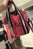 I love this bag! It's just so cute! I love the red and white plaid pattern with the short and long black straps. All the keychains are so fun, too! I wanted something simple that didn't look too flashy or expensive, and something that could be easily washed, and this is it. The material is cloth canvas and cleans up easily. - Victoria J.