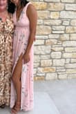 This dress looks just like the picture! It's pretty long. I'm 5'11 and wore heels, and it was still touching the ground. The band in the middle around the chest is pretty tight but not unbearable. - Sundara C.