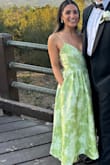 I'm 5'0 and around 107 lbs, and I loved the way this dress fit! It was fitted and structured through the bust and waist, which gave me a really flattering shape without feeling overly tight. The waist hit me in just the right spot, and the full A-line skirt balanced out the fitted bodice beautifully. The length was definitely long on my petite frame, but with heels it worked well. The sage green floral fabric is even prettier in person and has a beautiful, elegant texture. Overall, the fit was very flattering for a petite frame and gave me a defined waist with a romantic, feminine silhouette. - Keren M.
