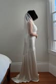 It has been extremely difficult to find a wedding dress that doesn't have a super deep neckline, isn't backless, is long enough for 5'8 (including heels), AND budget friendly. But this dress checked off all of those! I'm excited to wear this to our civil ceremony :) I did read about the wrinkles in the other reviews, and I can confirm that they do wrinkle easily (just putting the dress on at home wrinkled it), but I think I can work with it at the city hall; I'll just bring a steamer. - Suji I.