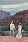 This dress was exactly what I was looking for, simple and elegant. The ivory color is more flattering on me than white and went well with the scenery. I got lots of compliments, and no one could believe I bought it online for such a great price. I didn't have to make any alterations. The small train makes it special - Nicole M.