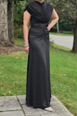 I'm a 34 B, and the bust area did not stay up. The dress is essentially strapless since the whole cape area is mesh, and you have to wear a strapless bra; otherwise, it ruins the look. So I spent the night feeling like the dress was sliding down, and I had to keep readjusting it. There were also a few pics where I stood to the side and got a pic with my side boob. Oops! I love the dress, but not sure I would pick it again if given the choice. - Jessica L.