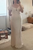 I got this dress as an option for some of my wedding events. I'm 4'11" and got an XS and it fit great! My chest is 32D and I have a booty and wider hips, so finding something that is flattering without being too long can be tough. The dress is floor length for me, but with some small heels it'll work. The sleeves are larger and puffier than I'd imagined, so I'm considering getting those altered to reduce the amount of fabric. I think on a more average-sized person, the sleeves would be less overwhelming. Overall, it's a great quality dress with pretty details! - Laura L.
