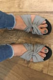 I read the reviews and ordered a half size up, so 7.5, and am glad I did. They DO a run narrow, and I have narrow feet so they are pretty snug, but perfect for my baby feet. I am so excited to wear them on vacation in two weeks. I just wore them around the house and they are very cushy and comfortable. Don't mind my gross nail polish in the pics! - Corrie N.