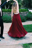 The skirt of this dress is big. The dress will flow behind you when you walk and spread out when you turn. It is so comfortable, that on the way home from our event I fell asleep in it. The sides of the top have grips so I did not feel like it would move too much. Overall a perfect dress that I will continue to wear. - Kate W.