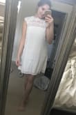This dress looks as good as the photos online! It fits just like it looks on the model, as long as you order the right size. I'm normally a small but ordered an xs because I didn't want to look like a potato sack and it fits perfect. The material is high quality and you can't see through it at all. Would highly recommend for a bridal shower or bridal event. - Marley