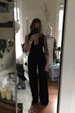 This jumpsuit is a must have. I was a little unsure about what size to get because the reviews are conflicting and some said it runs small. I completely disagree this fits perfectly! I'm 5'1" so I figured I should go with the XS for length. It fits like a glove and is extremely flattering not to mention comfortable because of how stretchy it is. It is long but I will probably never wear it without heels and with heels it's perfect. I was also very happy that it held up my 32DDD chest without a bra. Get this you won't be disappointed! - Alex B.