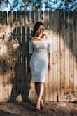 I bought this dress in a size small. When I received it in the mail I was a bit hesitant to try it on since the material felt a bit thick like linen. I put it on anyway and WOW, it revealed my curves in all the right ways. Even looked like I have a booty!  The material is stretchy enough that it was easy to put on, hug your curves, and zip up. I wore this to my bridal shower this month with high-waisted spanx underneath to give my tummy and sides a "smoother" look since my panty line showed through. I could have done without the spanx since the dress bunched up in the mid section when I sat down and got up again...but BOY did I receive countless compliments and stares all day in this dress. Totally recommend it! - PATRICIA M.