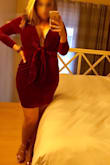 Such an awesome dress. Got it to wear to the Moulin Rouge... it didn't disappoint! With the cut and stretch of the fabric, it seems to run a full size large. Even ordering a size down, I wished I would've had time to have the shoulders taken up before my trip. As a larger-busted individual, the deep V was a gamble, but I was able to wear it with a U-plunge bra. The fabric feels luxurious and the color is a deep ruby red. - Jessica