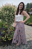 It's a little snug around the waist, but I would stick with the medium. It's a light and soft fabric, if the wind catches it right you'll flash everyone, so I might use a little fabric tape to give it a real closing. Wish the white top the model is wearing in the picture would come back in stock because its a perfect pair! - Lisa C.