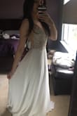 I bought this dress for my upcoming bridal shower. This dress is even more beautiful in person. The detailing on the top is exquisite, doesn't look cheap at all with the different bead/stones, it's gorgeous. I was nervous about the padding in the cups being to visible but you can't tell when you're wearing the dress. The bottom was a lot more fabric than I thought it was going to be but it's still very flowy. It's really long, I'l have to get it altered about 4 inches off but all in all I love this dress and I can't wait to wear it! - Natalie B.