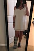 If you hang dry and think it still shrinks in length, try ironing it! Mine with right back to normal! Got lots of compliments on this dress! - Kristen T.